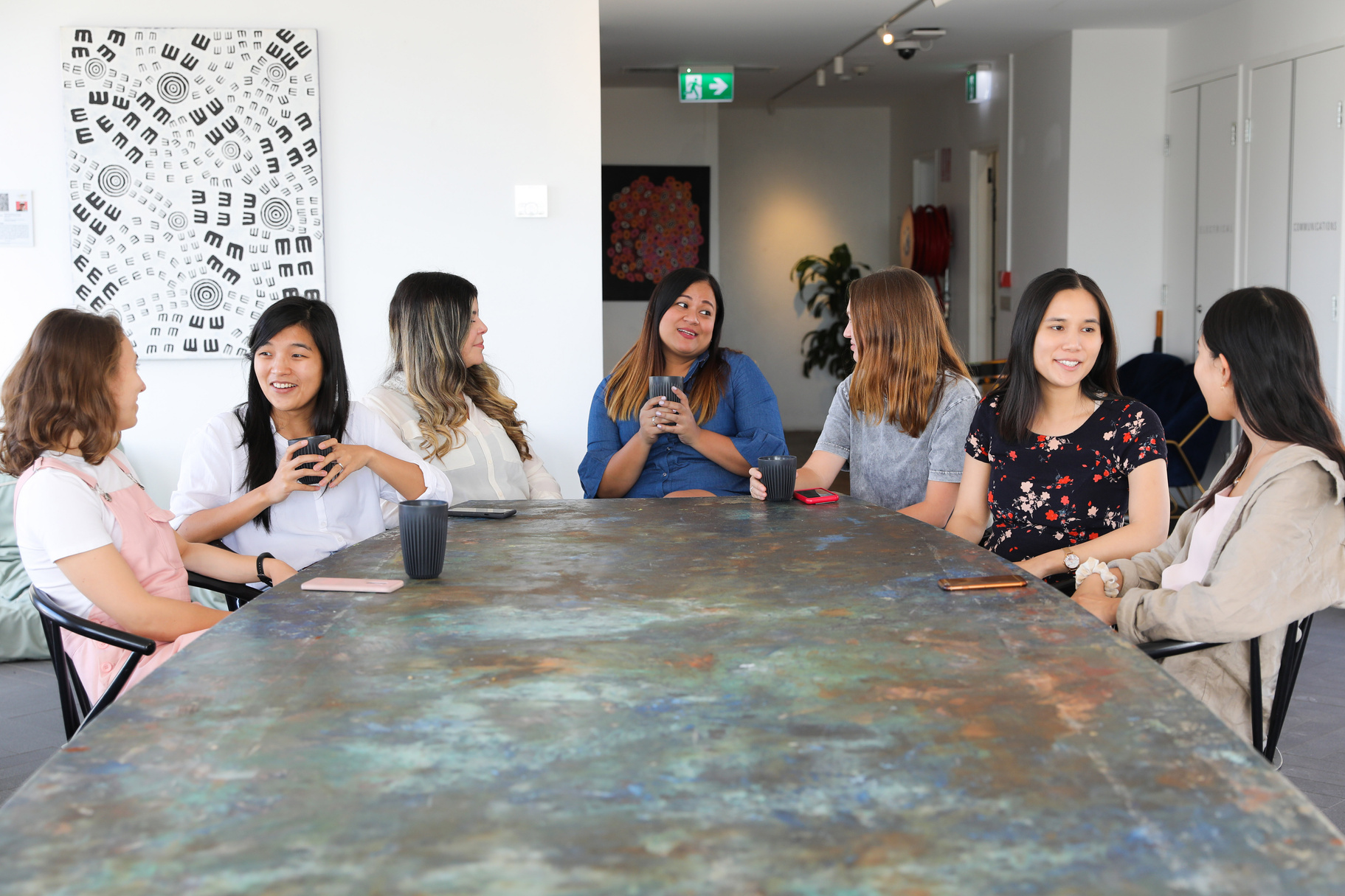 Women talking over coffee in the office
