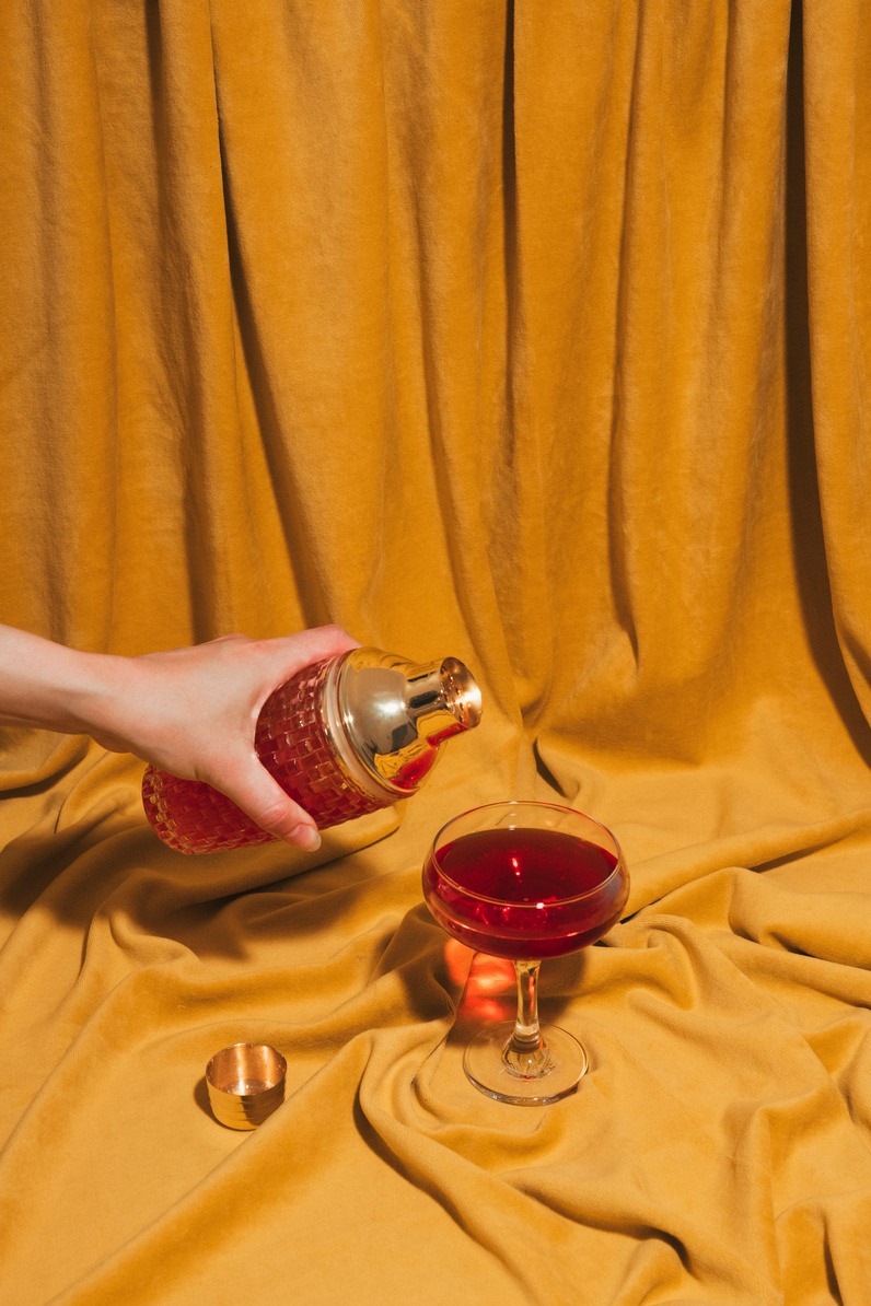 Person Pouring Beverage into a Glass